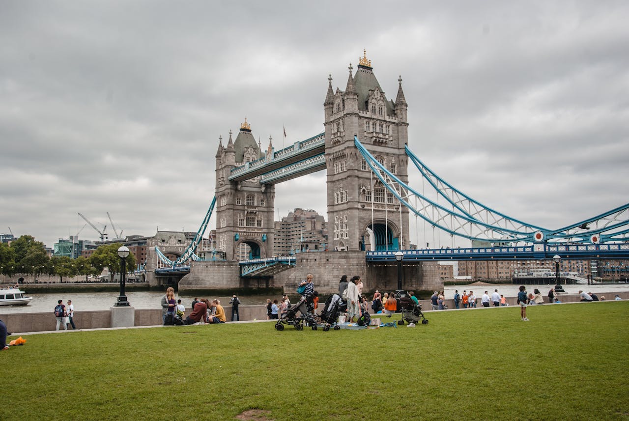 Tower Bridge in London, featuring its iconic twin towers and suspension design against a clear blue sky